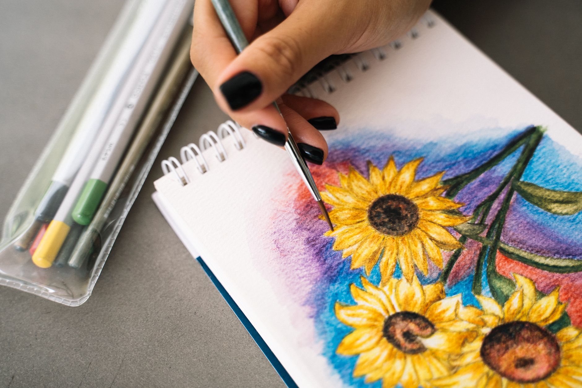 Watercolour painting of yellow sunflowers in a glass jar